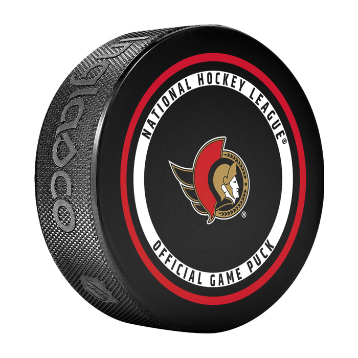 NHL Ottawa Senators official game puck face with red, gold and black centurion crest and league wordmark