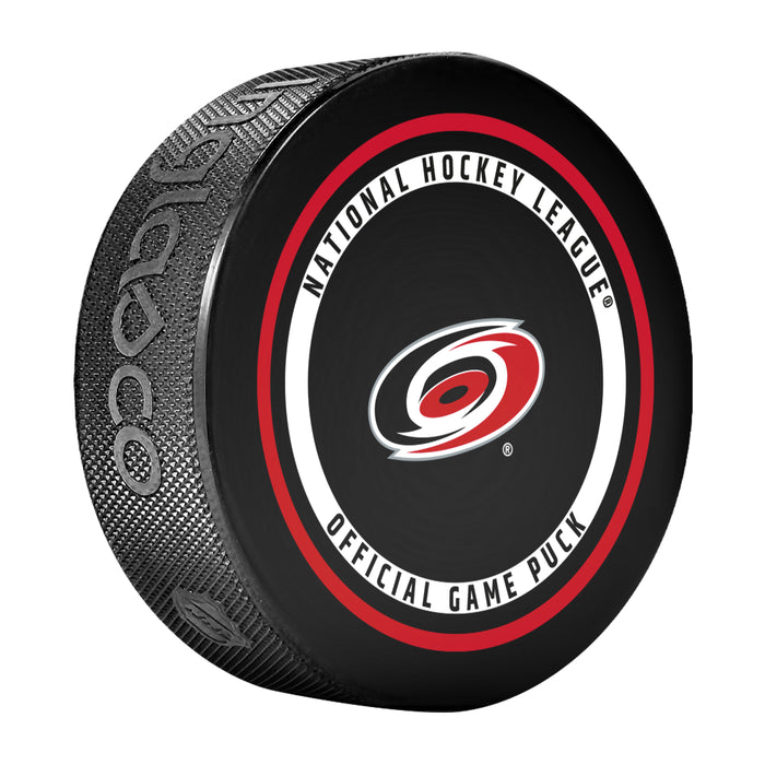 Carolina Hurricanes NHL Official Game Puck angled view with red and black circular border around team logo