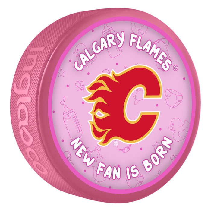 NHL Calgary Flames New Fan Is Born pink souvenir hockey puck with red flaming C logo on baby-themed background